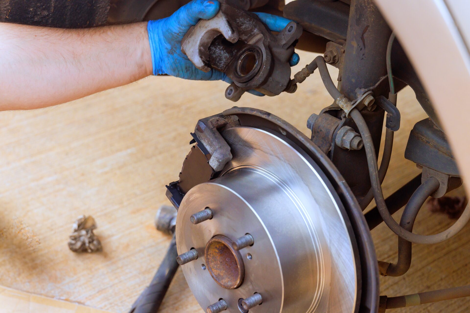 Mechanic,worker,is,replacing,brake,caliper,on,car's,disc,brake